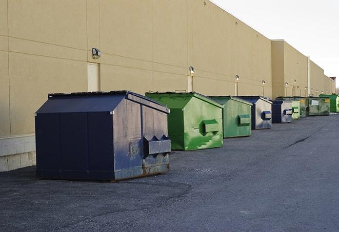 construction workers loading debris into dumpsters on a worksite in Deerfield Beach FL